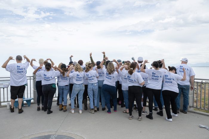 Maggie Sottero team members wearing "Be Their Voice" T-Shirts while volunteering