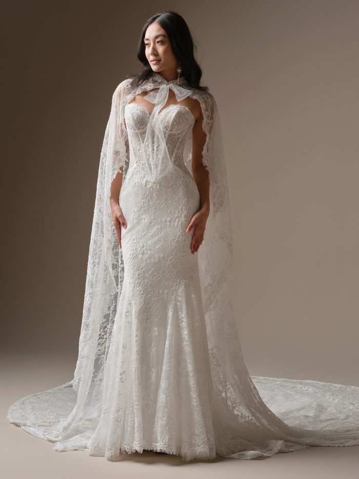 Bellevue by Maggie Sottero fit-and-flare wedding dress in unembellished Chantilly lace featuring an illusion bodice with exposed boning and an extended lace train