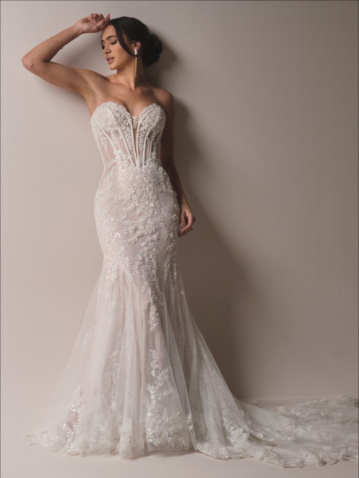 Bride wearing the Benjie Royale fit and flare wedding dress featuring a strapless illusion corset bodice, beaded lace motifs, and a soft tulle skirt with a chapel train.