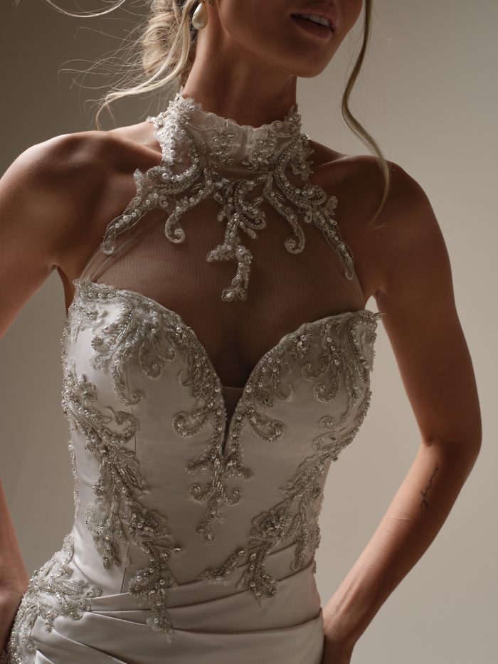 Close up of the Cressida by Maggie Sottero wedding dress featuring a beaded sweetheart bodice with illusion halter neckline.