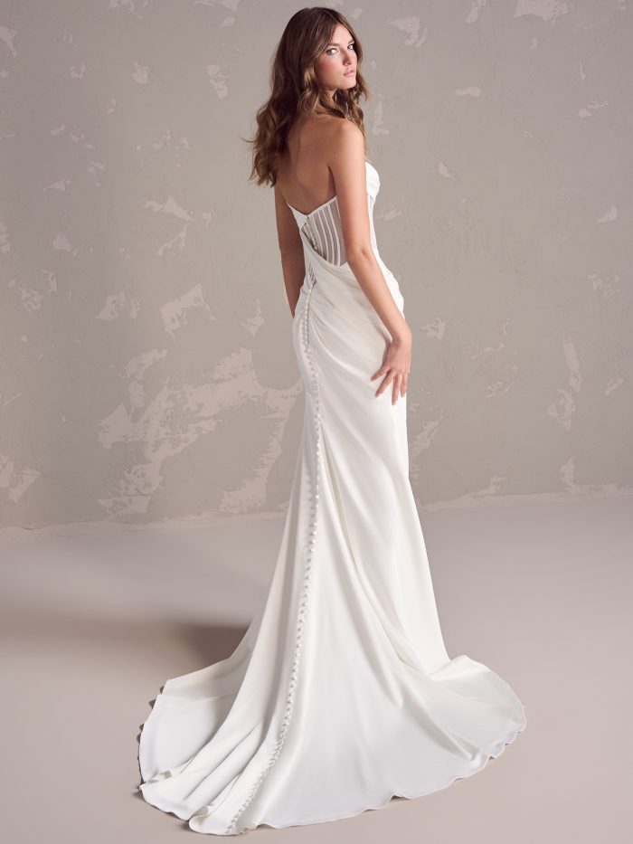 Bride wearing a sheath wedding dress with an illusion bodice
