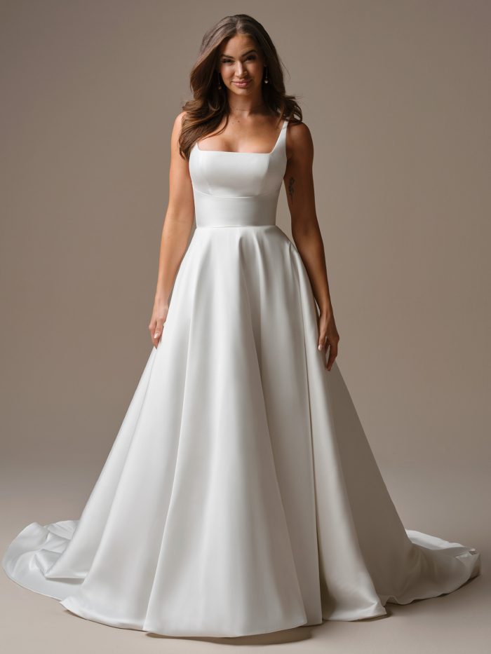 Galina by Maggie Sottero — elegant satin A-line wedding dress featuring a chic square neckline, fitted bodice, and thick straps for a timeless bridal look.