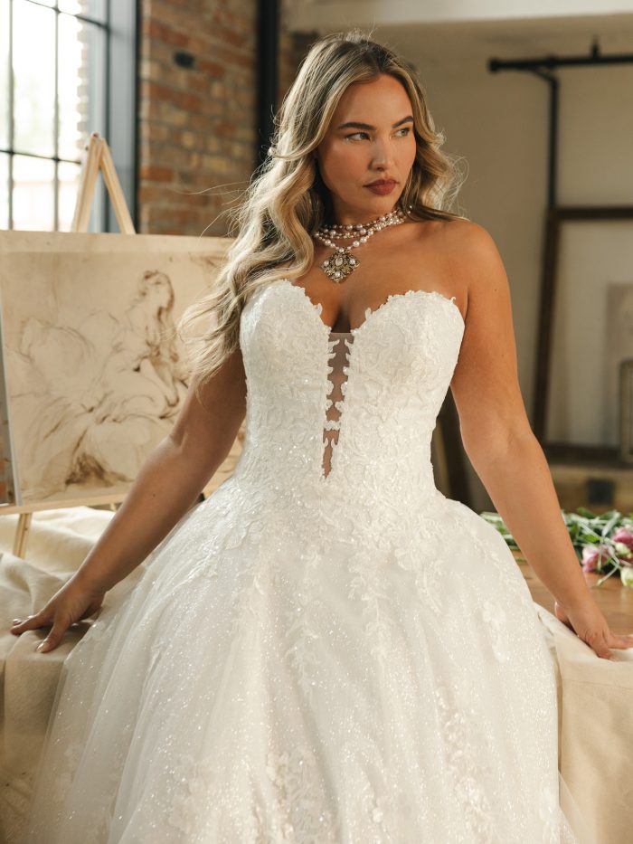 Jennifer ballgown wedding dress with a strapless sweetheart bodice, floral lace detailing, and shimmering tulle skirt shown in a close up studio shot.