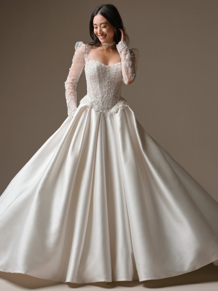 Maggie Sottero London ballgown wedding dress with beaded lace corset bodice, long illusion sleeves, and full satin skirt