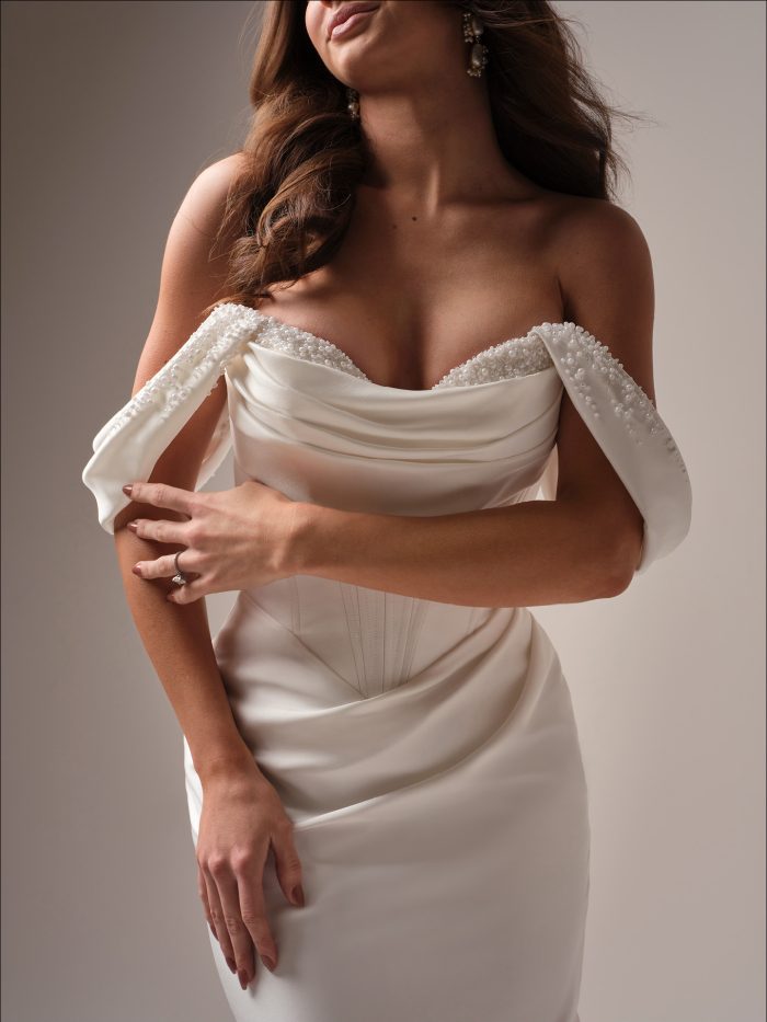Close up of the Melissa wedding dress showcasing the draped sweetheart neckline, beaded off the shoulder straps, and structured bodice details.