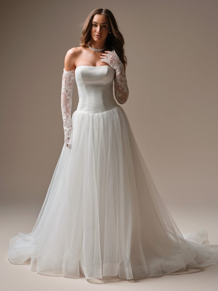 Shirley by Maggie Sottero — strapless A-line wedding dress featuring a structured satin bodice, soft tulle skirt, and detachable lace gloves for a modern romantic look.