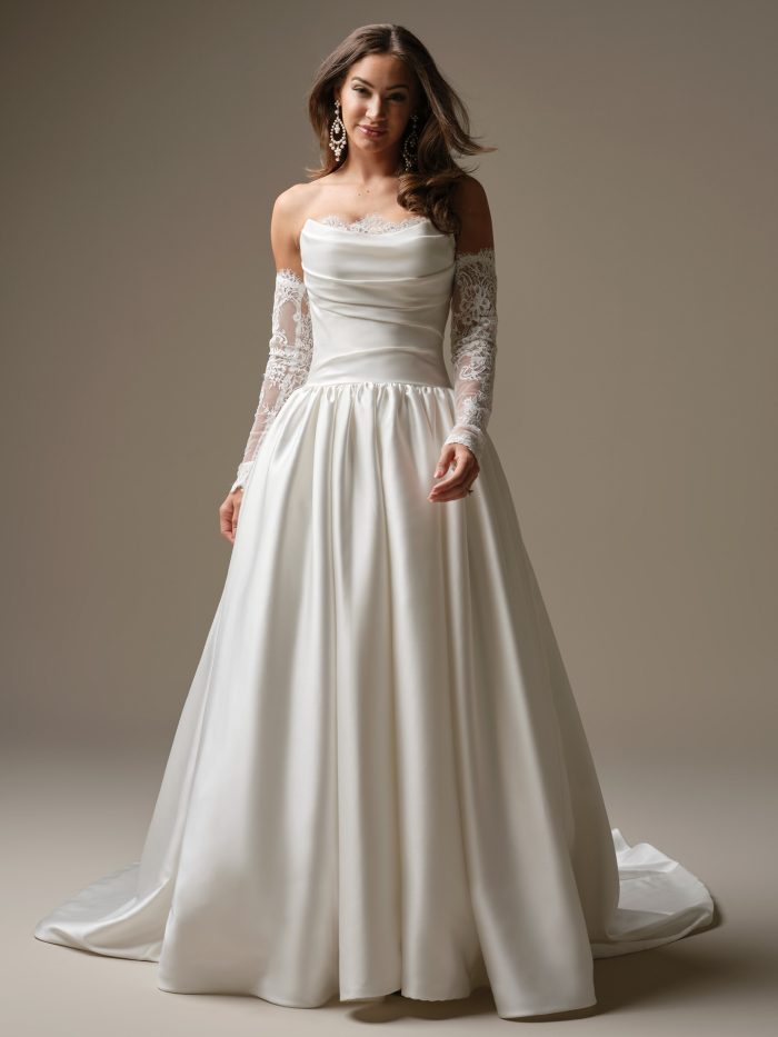 Sylvana by Maggie Sottero — romantic satin ballgown wedding dress featuring a draped cowl neckline with lace trim and detachable illusion lace sleeves