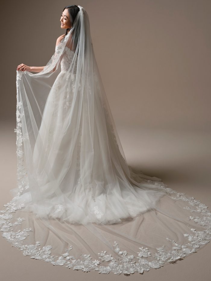 Back view of the Verina veil by Maggie Sottero, featuring intricate floral lace edging and dramatic cathedral-length styling for a romantic, vintage-inspired bridal look.
