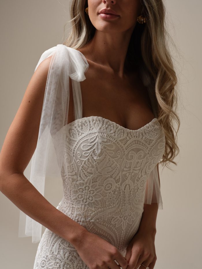 Close-up of the Rebecca Ingram Berkeley wedding dress highlighting the lace bodice, sweetheart neckline, and detachable soft tulle self-tie straps.