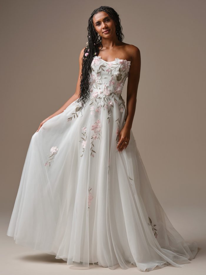 Bride wearing the Blossom A-line boho wedding dress with soft tulle layers, delicate floral embroidery, and a flowy, romantic silhouette.