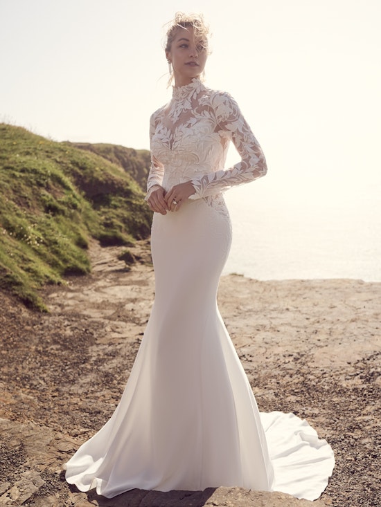 Bride walking on the beach in a simple crepe wedding dress