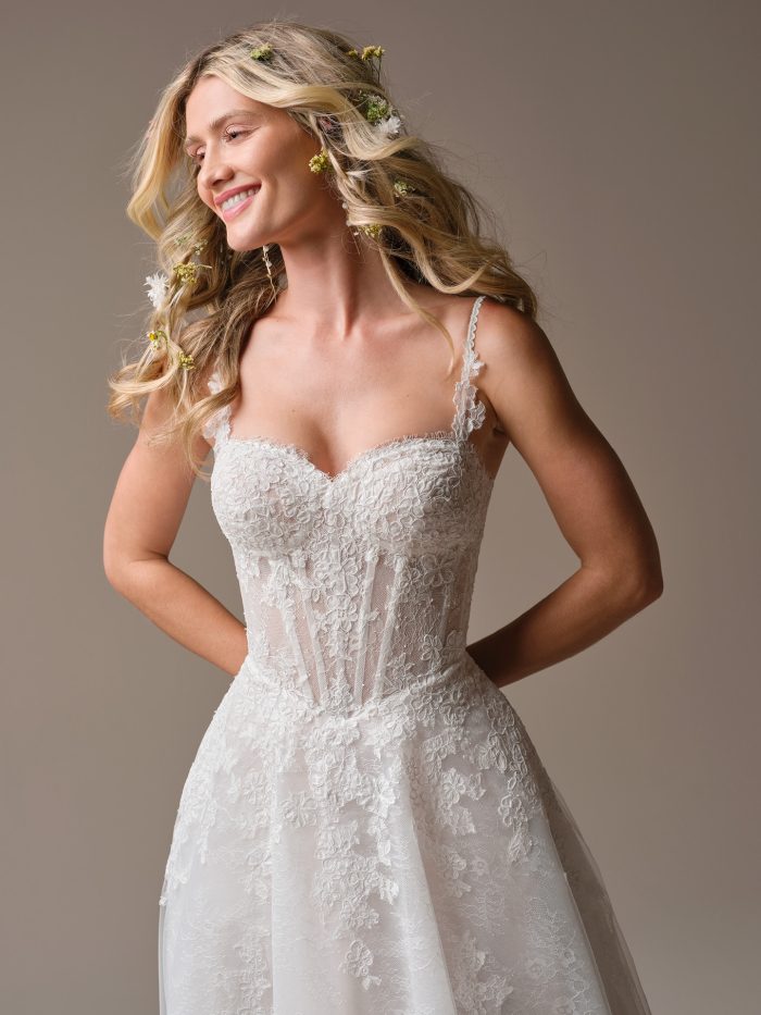 Close-up of the Esmeralda wedding dress featuring a sweetheart neckline, illusion lace bodice with exposed boning, and intricate floral lace details.