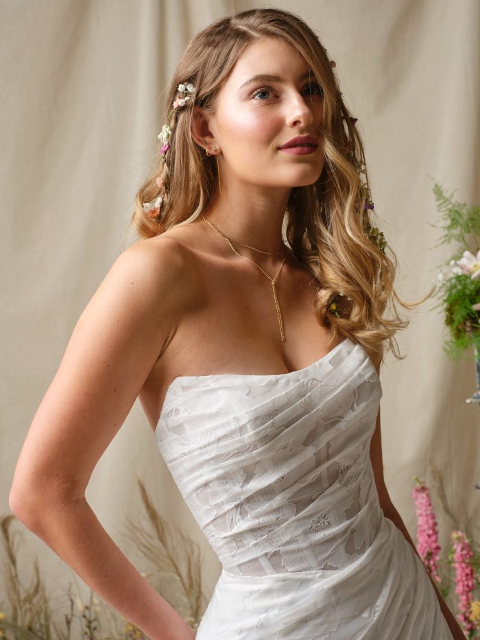 Close up of the Kendall wedding dress showing the printed organza, illusion bodice with exposed boning, and strapless cat eye neckline.
