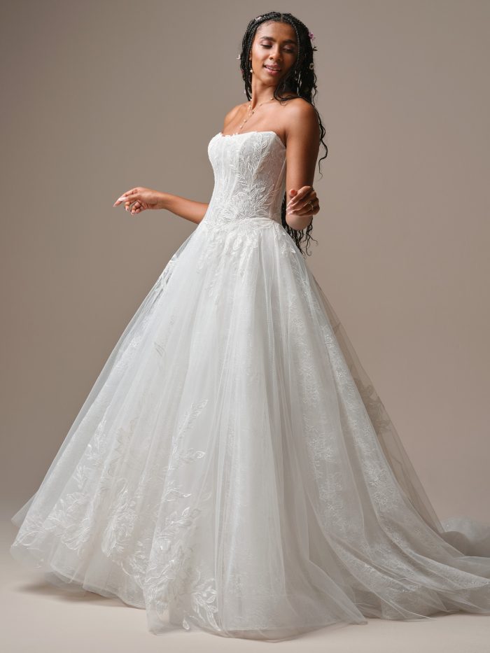 Lisa by Rebecca Ingram lace ballgown wedding dress with a strapless bodice, floral lace details, and a full flowing tulle skirt