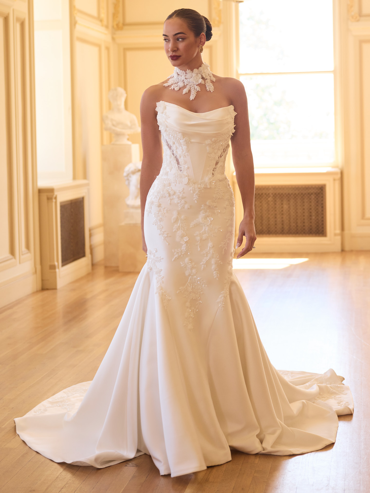 Burke fit-and-flare wedding dress featuring beaded sequin lace, structured corset bodice, strapless neckline, and soft flared train.