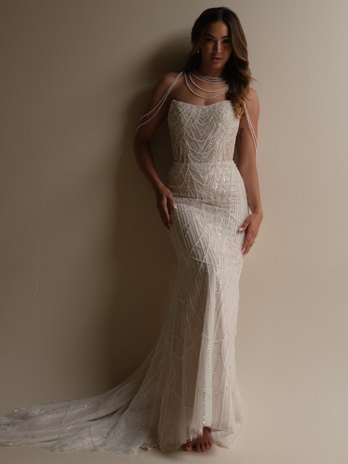 Front view of Sottero and Midgley Constance sheath wedding dress featuring intricate geometric beading, strapless neckline, and soft tulle train for a glamorous art deco look.