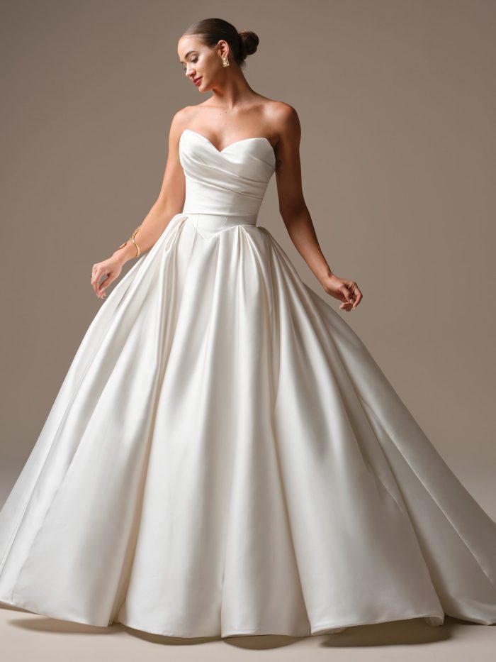 Elias by Sottero & Midgley satin ballgown wedding dress with a draped strapless bodice, defined waist, and full flowing skirt