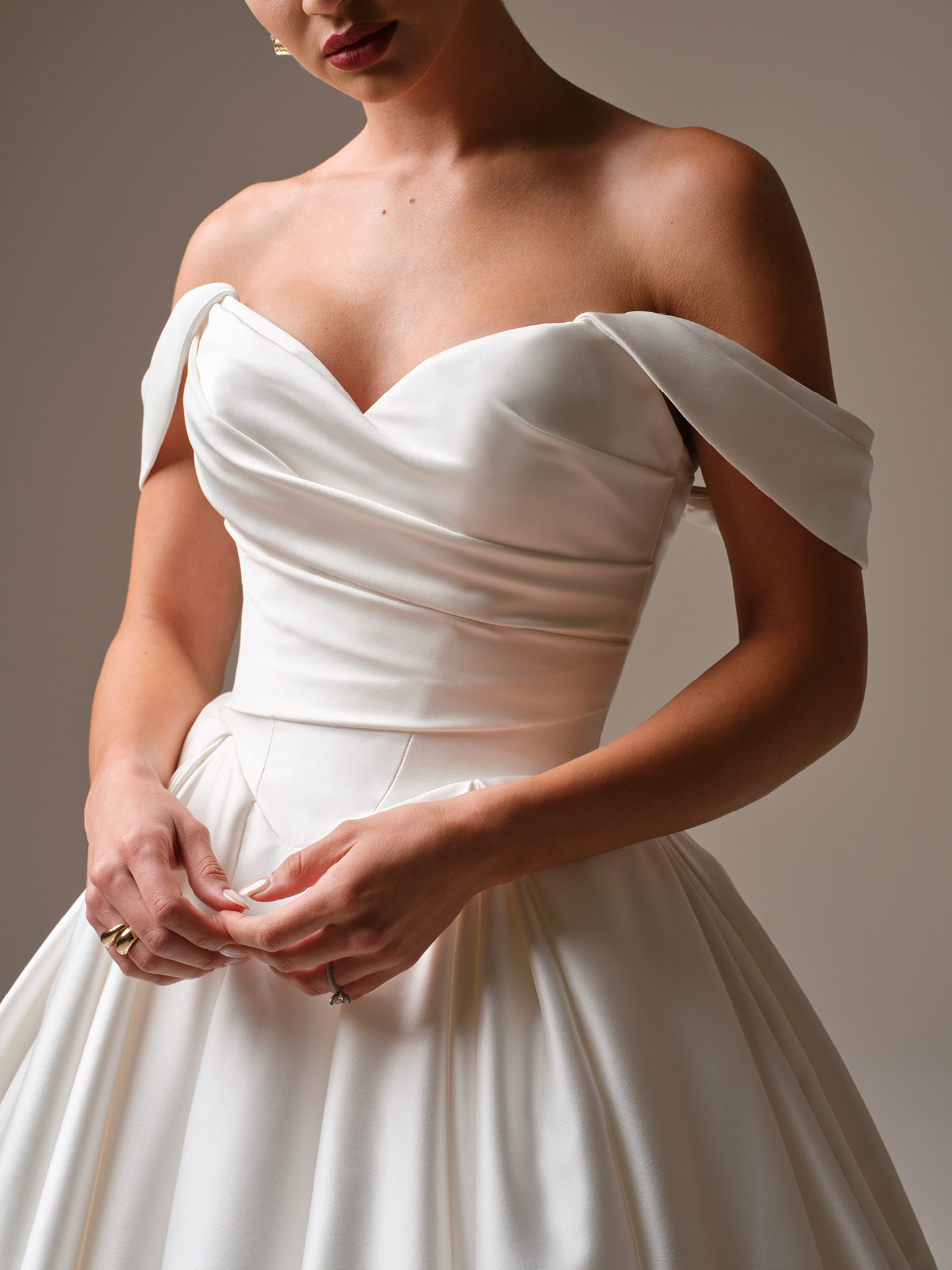 Elias satin ballgown wedding dress with strapless draped bodice, sweetheart neckline, and structured Basque waist detail.