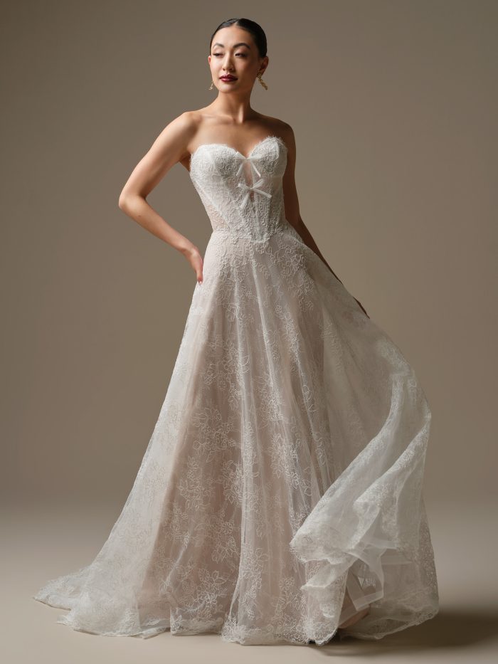 Bride wearing the Granger wedding dress, a strapless lace A-line gown with a sweetheart neckline and corset-style bodice, featuring delicate floral lace and soft layered tulle.