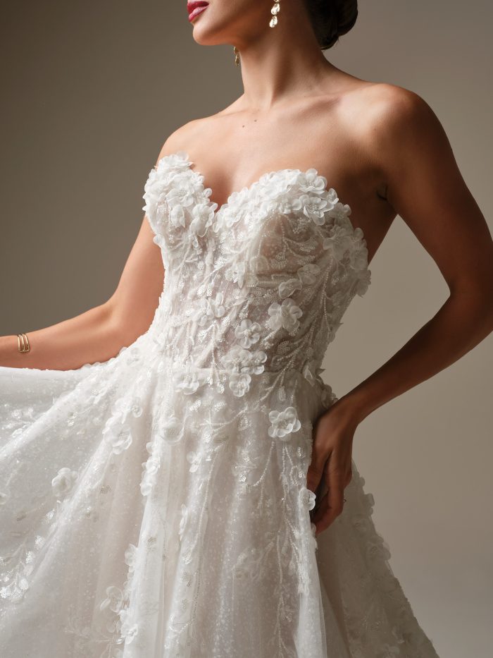 Close-up of Kalinda by Sottero and Midgley, featuring a strapless sweetheart neckline and illusion corset bodice adorned with dimensional floral lace and beaded detailing.