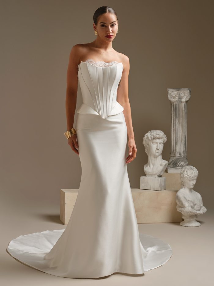 Lassen Marie by Sottero & Midgley satin sheath wedding dress with a corset-style bodice, basque-inspired waist, and smooth fitted skirt