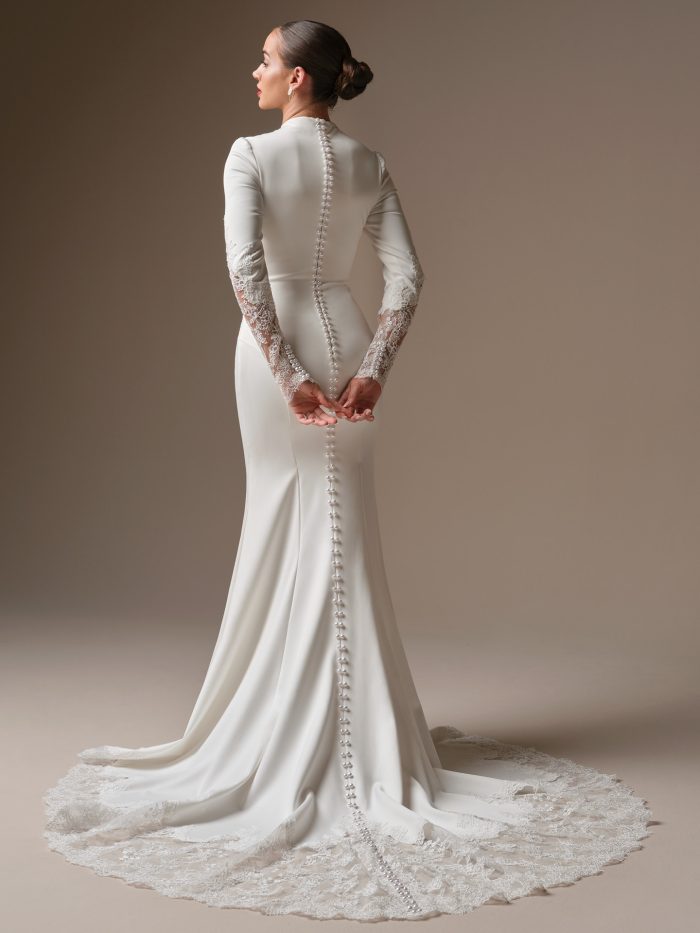 Back view of Sottero and Midgley Lovai wedding dress featuring pearl button-back detail and lace-trimmed train