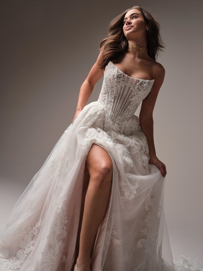 Front view of Sottero and Midgley Parker A-line wedding dress with strapless illusion lace bodice, thigh-high slit, and voluminous layered tulle skirt.