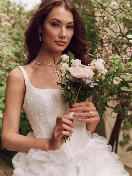 Bride wearing a Jacquard ballgown wedding dress with ruffle skirt