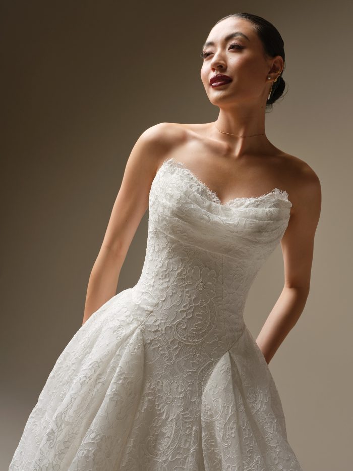 A close-up of the Sottero and Midgley Tamar wedding dress showing the draped lace sweetheart bodice and unembellished lace detailing.
