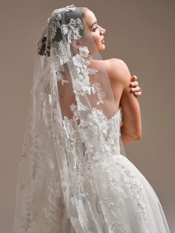 Back view of the Twilight Lane veil by Sottero and Midgley, showcasing its dramatic cathedral train with shimmering beaded lace and 3D floral embellishments.